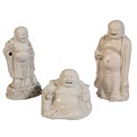 THREE CHINESE BLANC DE CHINE FIGURES OF BUDAI