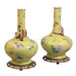 A PAIR OF CHINESE YELLOW GROUND FAMILLE ROSE INCISED BOTTLE VASES