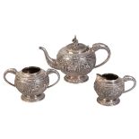 A THREE-PIECE WHITE METAL TEA SERVICE