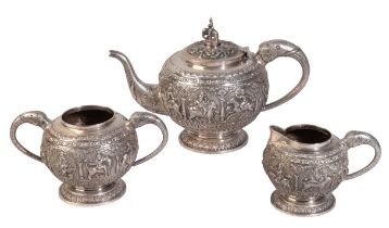 A THREE-PIECE WHITE METAL TEA SERVICE