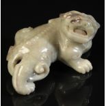 A CHINESE CELADON JADE BUDDHISTIC LION