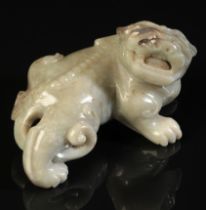 A CHINESE CELADON JADE BUDDHISTIC LION