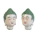 A PAIR OF CHINESE HEADS OF BUDDHA