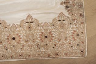 AN INDIAN SARI, IVORY SILK WITH HEAVILY EMBROIDERED BORDERS