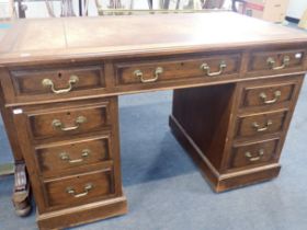 AN OAK PEDESTAL DESK, WITH SWAN-NECK BRASS HANDLES