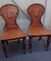 A PAIR OF VICTORIAN MAHOGANY HALL CHAIRS