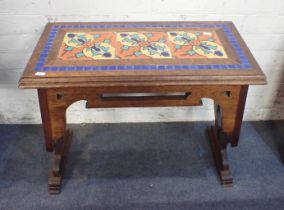 AN ARTS AND CRAFTS STYLE OAK AND TILED TABLE