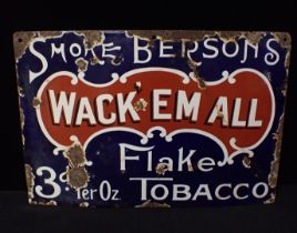 AN ENAMEL SIGN; 'SMOKE BERSON'S WACK 'EM ALL FLAKE TOBACCO'