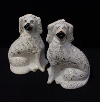 A PAIR OF 19TH CENTURY 'STAFFORDSHIRE' POTTERY SPANIELS