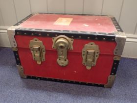 A SMALL RED 'OVERPOND' TRAVELLING TRUNK