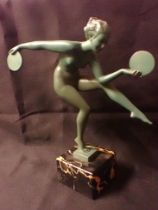 AN ART DECO PATINATED METAL NUDE DANCER WITH DISCS AFTER DERENNE