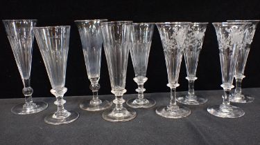 FOUR CHAMPAGNE FLUTES WITH ENGRAVED DECORATION