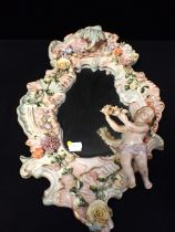 A DRESDEN STYLE MIRROR WITH PUTTO