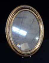 A 19TH CENTURY STAMPED BRASS FRAMED OVAL MIRROR