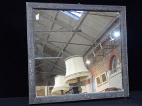 AN ARTS AND CRAFTS STYLE LEAD/PEWTER COVERED FRAMED MIRROR