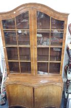 A REPRODUCTION FIGURED MAHOGANY BOOKCASE OF GEORGIAN DESIGN