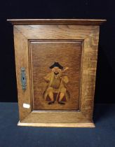 AN OAK SMOKER'S CABINET, IN THE MANNER OF SHAPLAND & PETTER