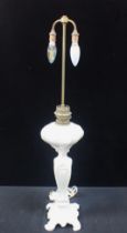 A WHITE POTTERY OIL LAMP CONVERTED TO ELECTRICITY