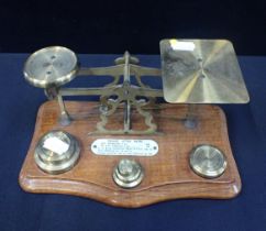 A POSTAL SCALE WITH BRASS WEIGHTS