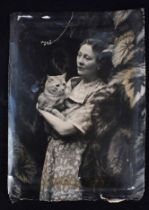 CECIL BEATON: A PHOTOGRAPH OF A WOMAN HOLDING A CAT