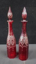 A PAIR OF BOHEMIAN RED GLASS DECANTERS