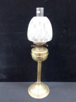 A BRASS TABLE OIL LAMP AND SHADE