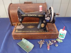 A VINTAGE OAK-CASED SINGER SEWING MACHINE