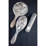 AN EDWARDIAN SILVER THREE PIECE HAIRBRUSH SET