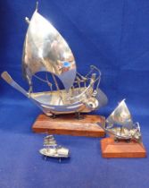 THREE WHITE METAL GRADUATED INDIAN BOATS