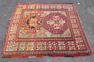 AN ANTIQUE KAZAK RUG