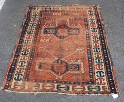 AN ANTIQUE KAZAK RUG