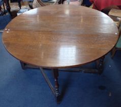 A LARGE OAK GATELEG TABLE