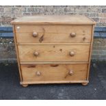 A STRIPPED PINE CHEST OF THREE DRAWERS