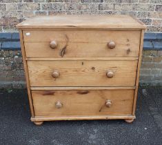 A STRIPPED PINE CHEST OF THREE DRAWERS