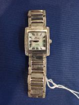 A SILVER CASED GEM SET WATCH