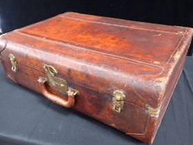 A VINTAGE LEATHER SUITCASE, WITH PATINATED SURFACE