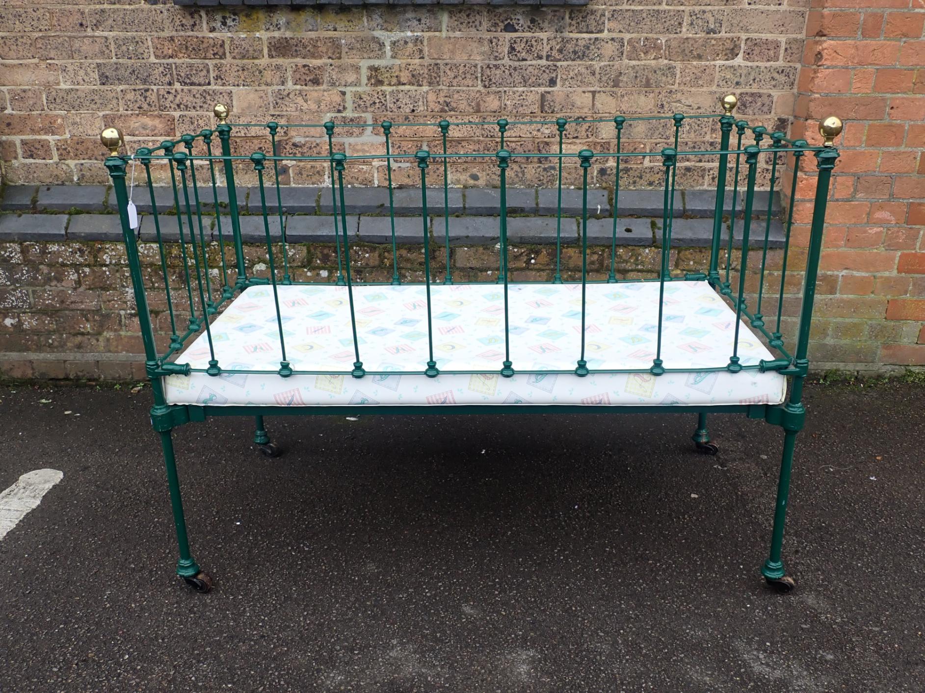 A VICTORIAN IRON COT, WITH BRASS KNOBS