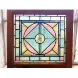A COLOURED LEADED GLASS PANEL, WITH WHORLED BULLSEYE CENTRE