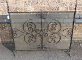 A SCROLLED WROUGHT-IRON FIRE SCREEN