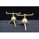 ATTRIBUTED TO DR CHRISTOPHER DRESSER: A PAIR OF BRASS FIRE DOGS