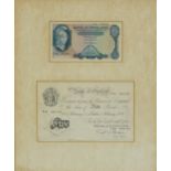 Two Bank of England five pound notes housed in a glazed framed display including a white example P S