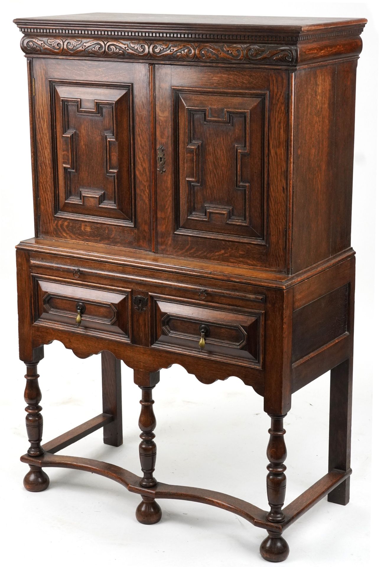 Jacobean Revival oak court cupboard fitted with an assortment of cupboard doors and pigeon holes