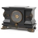 Victorian black slate mantle clock striking on a gong with bronze mounts and applied masks, the