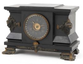 Victorian black slate mantle clock striking on a gong with bronze mounts and applied masks, the