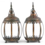 Pair of bronzed hanging lanterns with glass panels on paw feet, each 39.5cm high : For further
