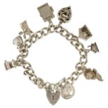 Silver charm bracelet with a selection of mostly silver charms including enamelled cow bell, wishing