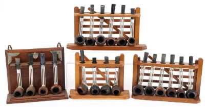 Twenty vintage Falcon aluminium and briar tobacco smoking pipes arranged in three pipe stands, three
