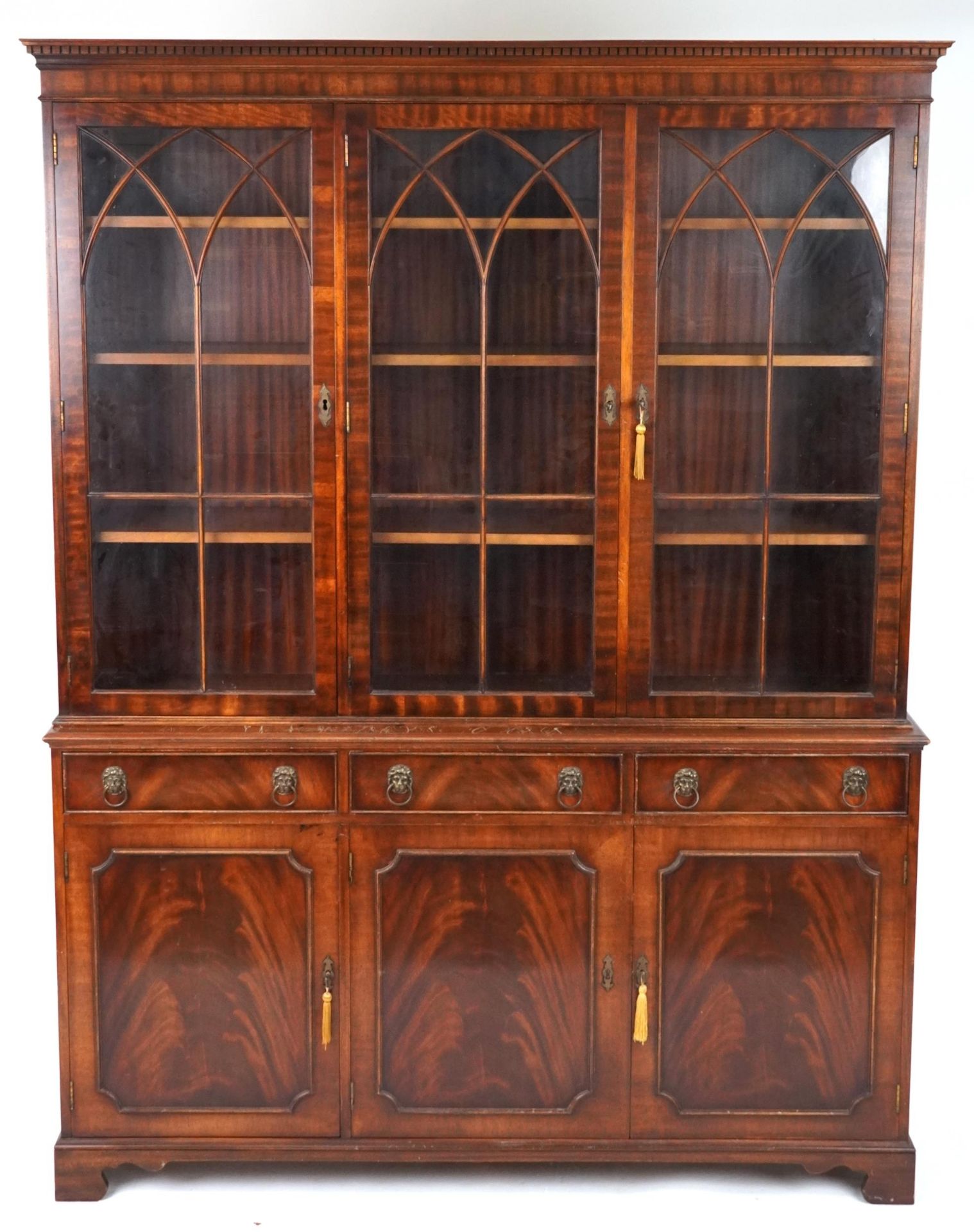 Georgian style mahogany library bookcase with lion mask handles, fitted with an arrangement of
