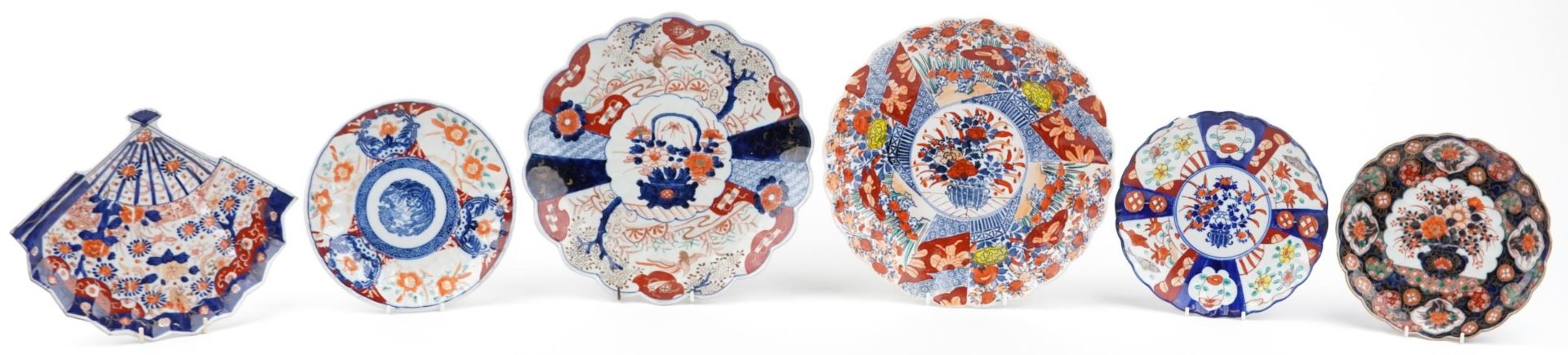 Japanese Imari porcelain comprising two chargers and four dishes, one in the shape of a fan, each
