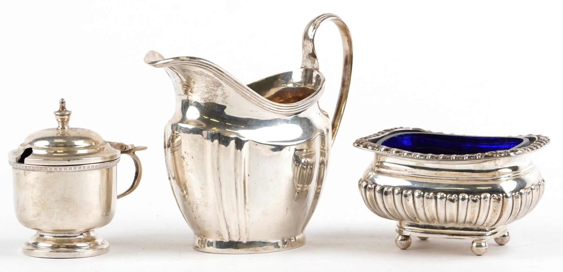 Silver objects comprising George V cream jug, demi fluted open salt with blue glass liner and